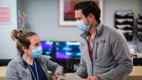 Two clinicians speak to each other